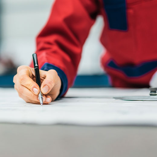 Contractor designing plans for a custom pond construction project